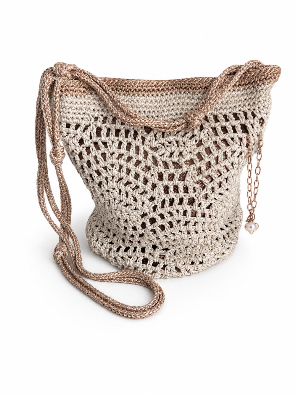 The Sak Woven  Crochet Bucket Bag in Beige and Rose Gold